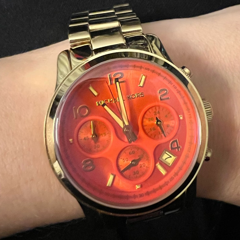 Michael Kors “Runway” iridescent gold tone watch.